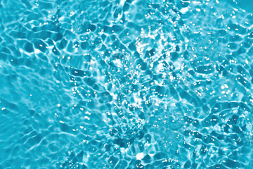 Blur Reflections of blue water or cosmetic moisturiser toner or lotion light with scattered sun texture