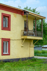 A fragment of the facade of an old house with an unusual balcony in Guryevsk