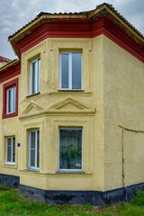 Fototapeta na wymiar Fragment of the facade of an old house on Lenin Street in Guryevsk