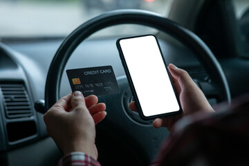  Close up of man hand using mobile smart phone payments and credit card for online shopping in car,Online shopping, digital banking, E-commerce concept.