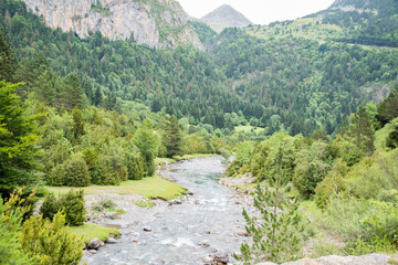 Meadows, lakes, rivers, woods  and mountains  in the Aragonese Pyrenees bordering the French border