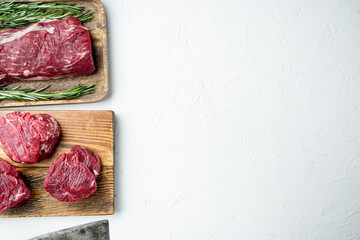 Fillet mignon steak raw, on wooden cutting board, on white stone  surface, top view flat lay, with...
