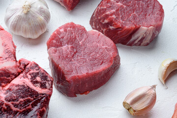 Fresh raw fillet minion steaks marbled beef with rosemary and garlic, on white stone  surface - Powered by Adobe