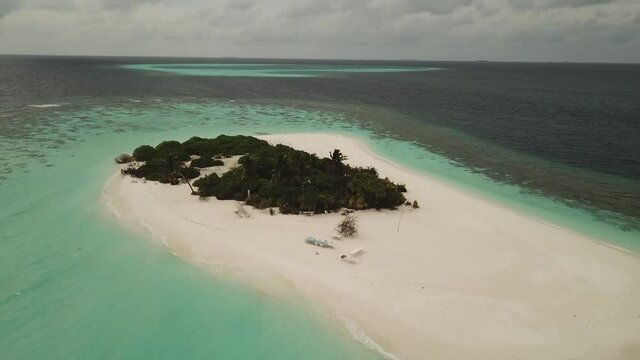 Aerial  Drone Tropical Island on the Maldives with white beaches and azure blue water