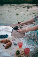 the girl takes out her perfume from her purse