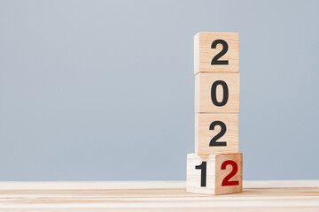 2022 wooden cube blocks on table background. Resolution, plan, review, goal, start and New Year...