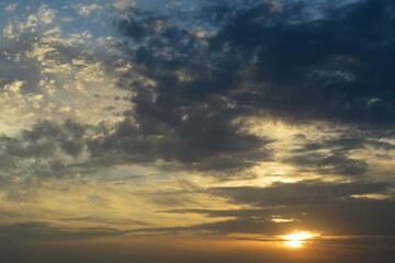 Fototapeta premium Dark dramatis clouds in the sky at sunset, natural background