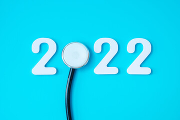 2022 Happy New Year for healthcare, Insurance, Wellness and medical concept. Stethoscope and white number on blue background