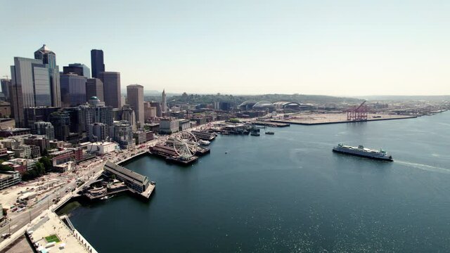 Slow Floating Aerial of Ferry Boat Pulling into Elliot Bay Dock at Seattle Waterfront
