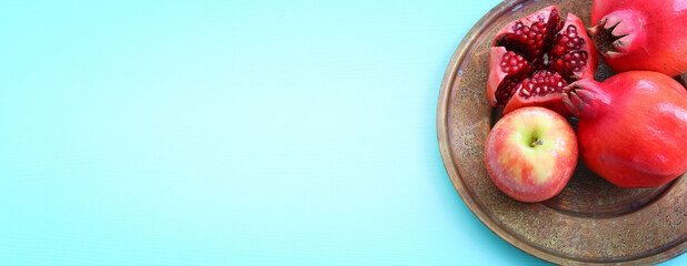 Rosh hashanah (jewish New Year holiday) concept. Pomegranate and apple raditional symbols