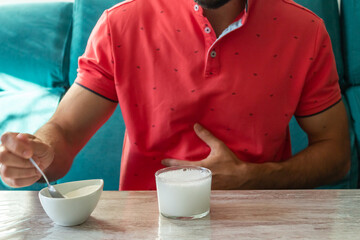 Caucasian man with stomach ache preparing fruit salt