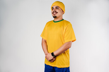 Brazilian fan watching Brazil's national anthem during the Brazilian national team game wearing a yellow jersey and yellow cap