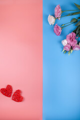 Flowers and hearts on a pink and blue background.