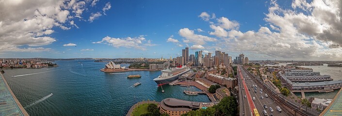 Aerial panoramic view of Sydney harbor from Harbor Bridge with skyline, opera house and cruise...