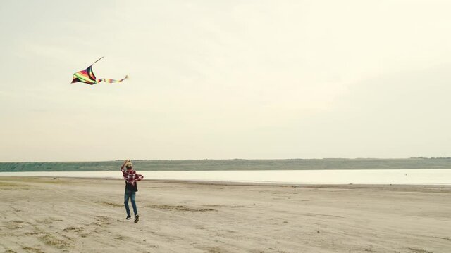 A little boy is playing with a kite on nature
