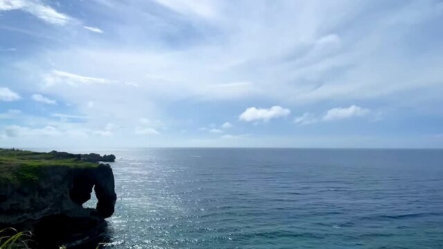 OKINAWA, JAPAN - JUNE 2021 : Cape Manzamo located near Onna son village in the Kunigami District. Wide view time lapse shot in daytime.