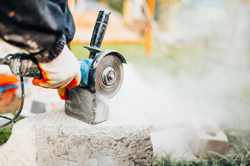 Dust from the work of a diamond blade on an angle cut-off machine - the work of a tiler on paving stones