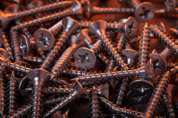 Galvanized self-tapping screws close-up in a creative color script.