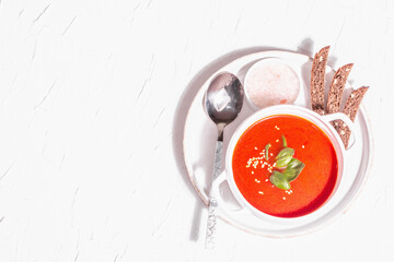 Red puree soup with tomato, greens, and bread