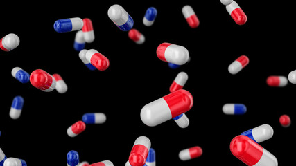 Medical capsules red-white and white-blue falling on a black background.