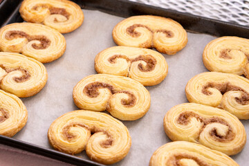 Fresh puff pastry palm cookies in the shape of a heart. Classic French pastries.food concept