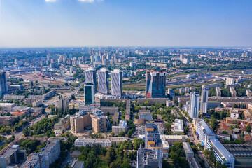 Aerial photography, sunlight illuminates urban residential areas and green parks in the summer blue haze.