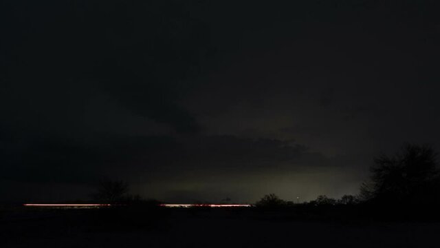 Time lapse of a dramatic storm over an interstate highway at night