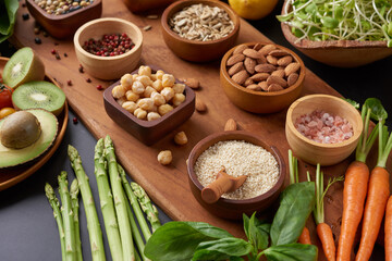 Different vegetables, seeds and fruits on table. Healthy diet..vegetarian, vegan food cooking ingredients. Flat-lay of vegetables, fruit, beans, cereals, kitchen utencil, dried flowers, top view.