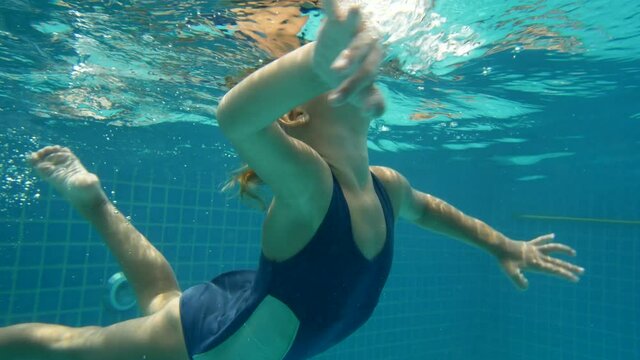 6 year old girl dives in the pool, underwater shooting