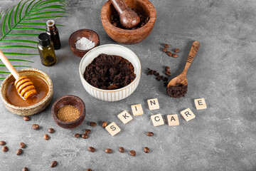 Ingredients for making homemade coffee skincare scrub on gray table. Eco friendly cosmetics