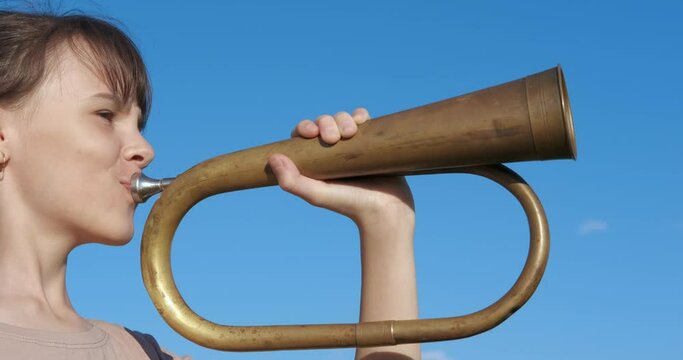 Child enjoy musical instruments. A teen enjoy the musical instruments and like to blow in her horn in the open air.
