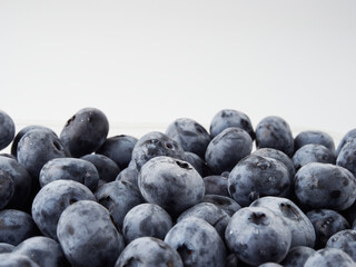 Water drops on ripe sweet blueberry. Fresh blueberries background with copy space for your text. Vegan and vegetarian concept. Macro texture of blueberry berries.Texture blueberry berries close up
