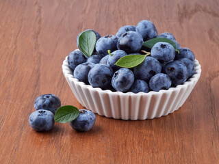 Blueberry fruit top view isolated on a white background, flat lay overhead layout with mint leaf, healthy design concept.