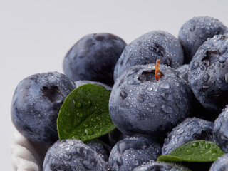 Water drops on ripe sweet blueberry. Fresh blueberries background with copy space for your text. Vegan and vegetarian concept. Macro texture of blueberry berries.Texture blueberry berries close up