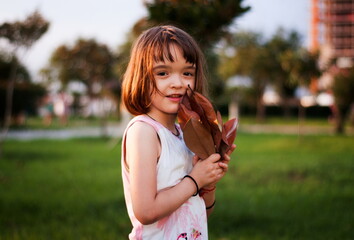Little girl having fun outdoors in sunset