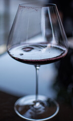 Red wine in a glass. Close up. Vertical. Selective focus.