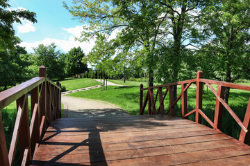 Wooden bridge in the park on hot summer day.