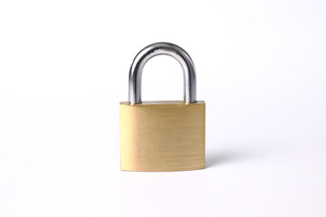 Fototapeta premium Close-up of a brass padlock with white background
