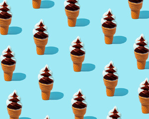Pattern of ice cream in a cone on a blue background. Summer minimum composition.