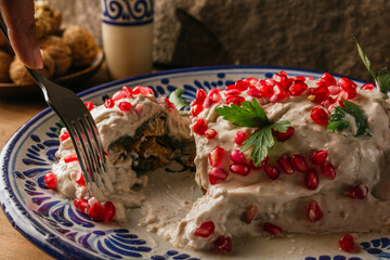 Chiles en Nogada, a 100% Mexican recipe with its main ingredients on one side, such as walnut,...