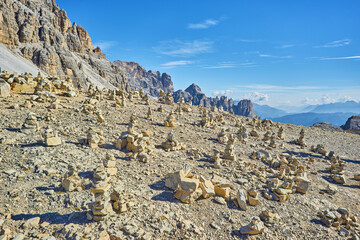 Stones gravel stack bellow Alpine mountain summit. Spring trail around Tre Cime di Lavaredo, well...