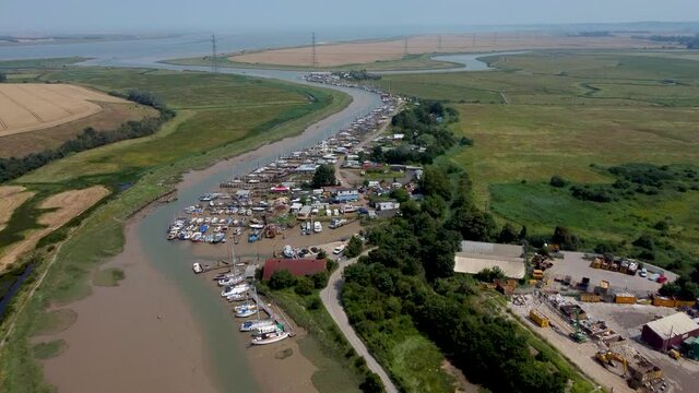 4K drone footage flying towards a boat scrapyard.