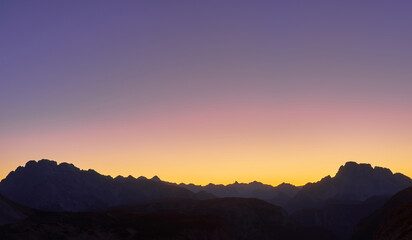 Tre Cime di Lavaredo, sunset scene, illuminated by red light, Italy