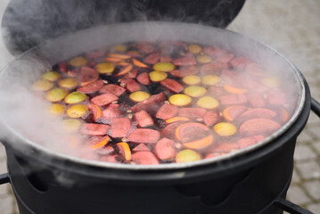 the chef prepares and pours hot mulled wine
