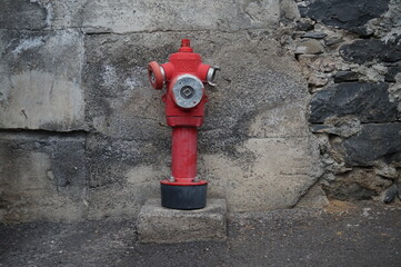 fire hydrant against gray wall