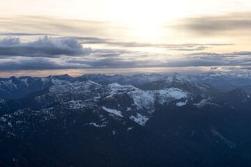 Obraz premium Aerial View from Airplane of Canadian Mountain Landscape in Spring time. Colorful Sunset Sky Art Render North of Vancouver, British Columbia, Canada.