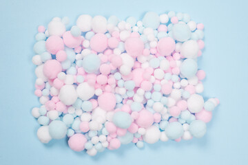 White, pink and blue soft pompons as a background.