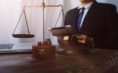 Business and lawyers discussing contract papers with brass scale on desk in office. Law, legal...