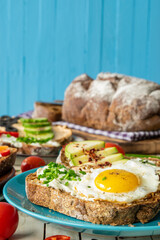 composition: sandwiches with vegetables, salmon and egg, on a wooden background, proper nutrition, selective focus

