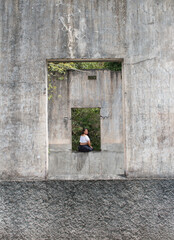 girl at window with gray wall